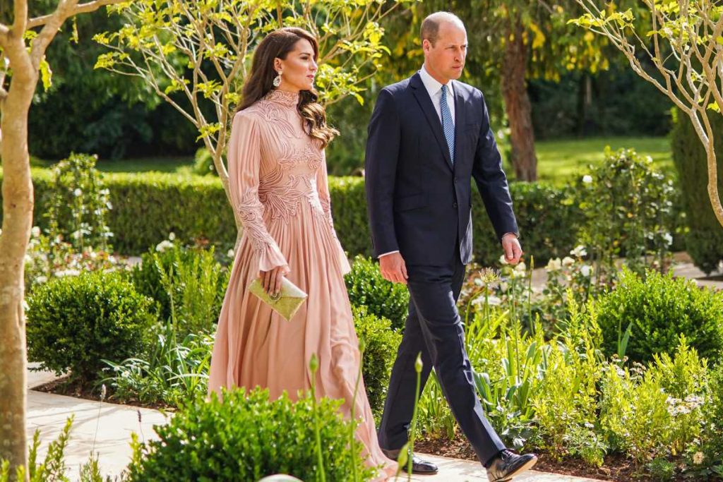 Prince William and Kate Middleton walking together at Prince of Jordan's wedding