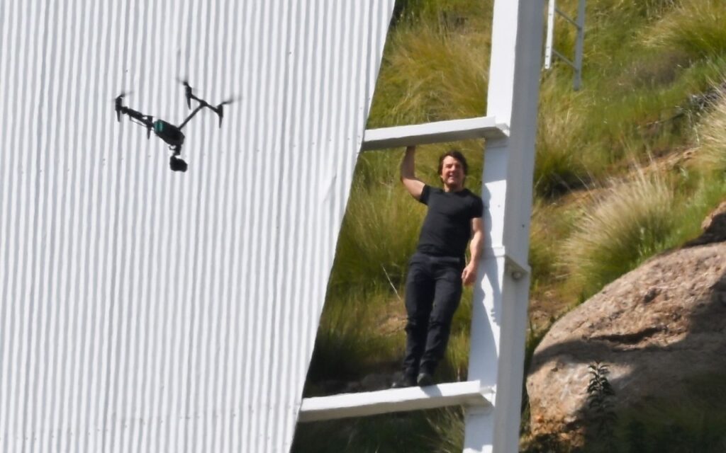 See photos of Tom Cruise climbing the famous Hollywood sign to shoot a commercial related to the Olympic theme.  - Photo: Grosby Group