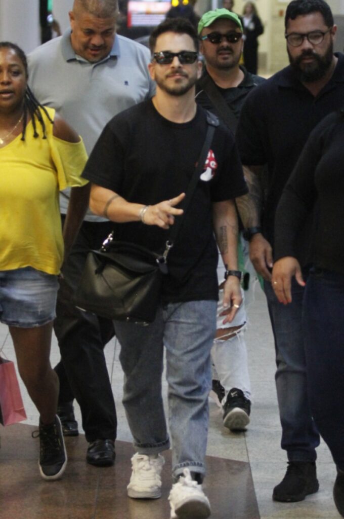 Junior Lima in black, at the airport